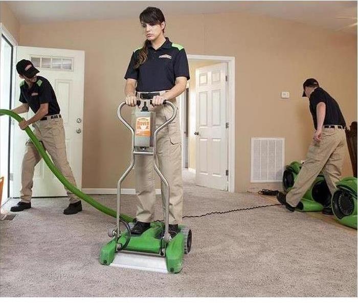 SERVPRO Technicians drying a living room